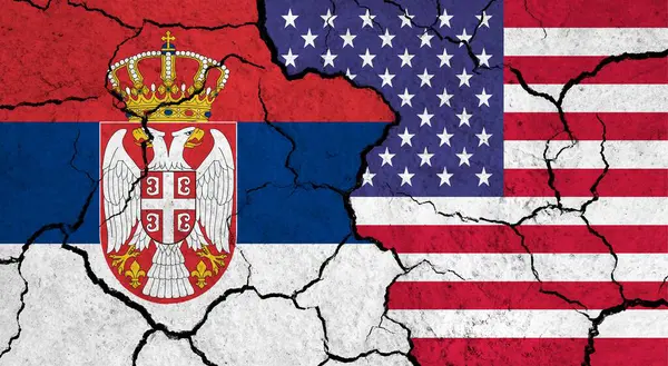 Flags of Serbia and USA on cracked surface - politics, relationship concept