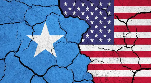 Flags of Somalia and USA on cracked surface - politics, relationship concept