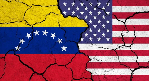 Flags of Venezuela and USA on cracked surface - politics, relationship concept