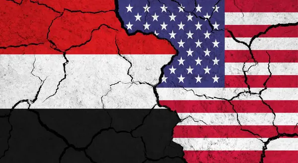 Flags of Yemen and USA on cracked surface - politics, relationship concept