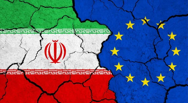 Flags of Iran and European Union on cracked surface - politics, relationship concept