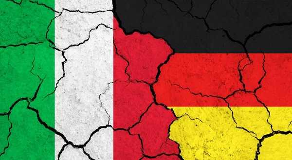 Flags of Italy and Germany on cracked surface - politics, relationship concept