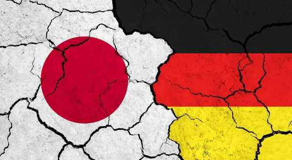 Flags of Japan and Germany on cracked surface - politics, relationship concept
