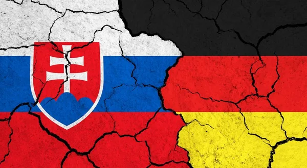 Flags of Slovakia and Germany on cracked surface - politics, relationship concept