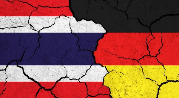 Flags of Thailand and Germany on cracked surface - politics, relationship concept
