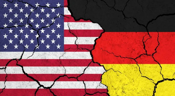 Flags of USA and Germany on cracked surface - politics, relationship concept