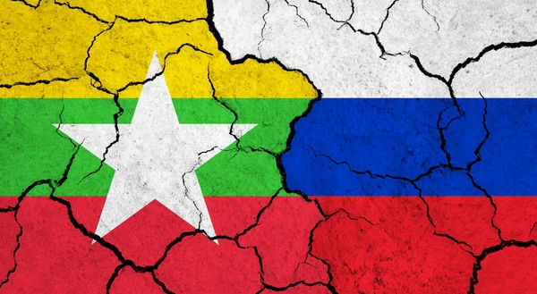 Flags of Myanmar and Russia on cracked surface - politics, relationship concept