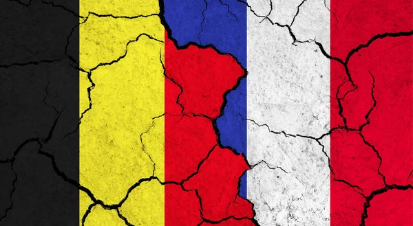 Flags of Belgium and France on cracked surface - politics, relationship concept