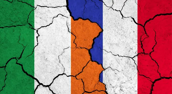 Flags of Ireland and France on cracked surface - politics, relationship concept