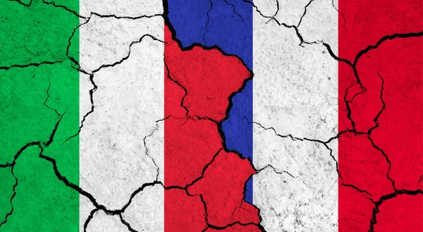 Flags of Italy and France on cracked surface - politics, relationship concept
