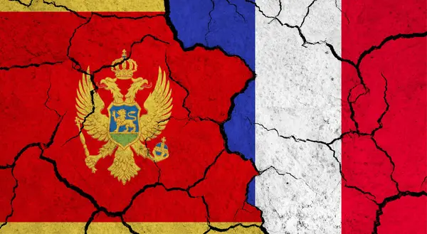 stock image Flags of Montenegro and France on cracked surface - politics, relationship concept