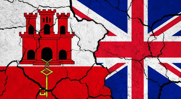 Flags of Gibraltar and United Kingdom on cracked surface - politics, relationship concept