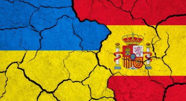 Çatlak yüzeyde Ukrayna ve İspanya bayrakları - politika, ilişki konsepti