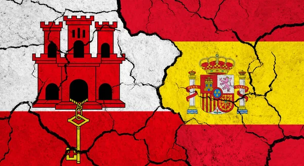 Flags of Gibraltar and Spain on cracked surface - politics, relationship concept