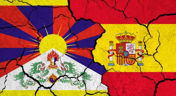 Flags of Tibet and Spain on cracked surface - politics, relationship concept