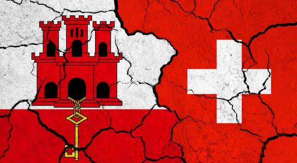 Flags of Gibraltar and Switzerland on cracked surface - politics, relationship concept