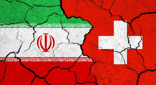Flags of Iran and Switzerland on cracked surface - politics, relationship concept