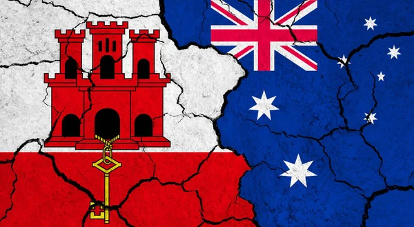 Flags of Gibraltar and Australia on cracked surface - politics, relationship concept