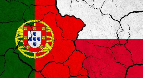 Flags of Portugal and Poland on cracked surface - politics, relationship concept