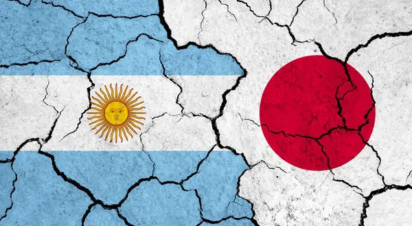 Flags of Argentina and Japan on cracked surface - politics, relationship concept
