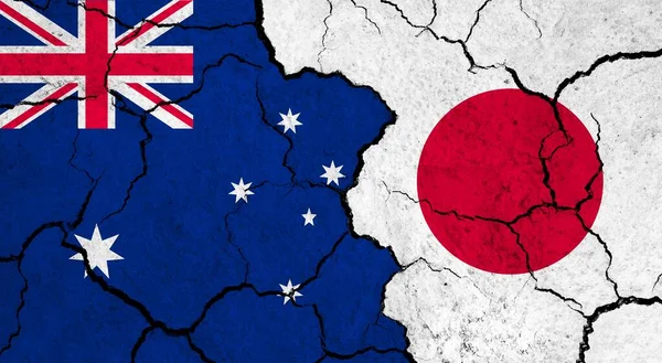 Flags of Australia and Japan on cracked surface - politics, relationship concept
