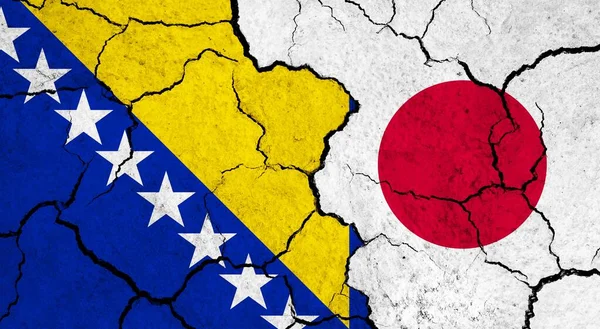 Flags of Bosnia and Japan on cracked surface - politics, relationship concept