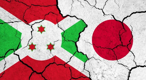 Flags of Burundi and Japan on cracked surface - politics, relationship concept