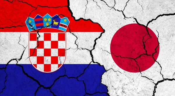 Flags of Croatia and Japan on cracked surface - politics, relationship concept