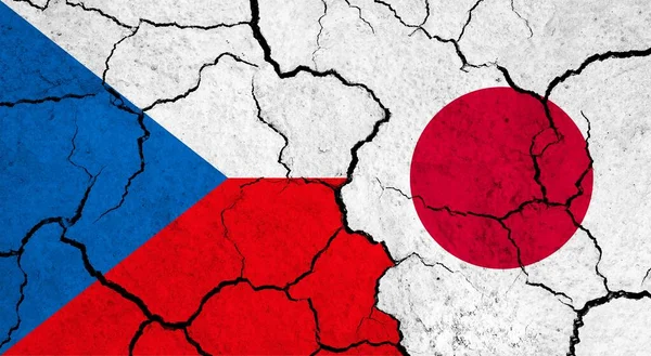 Flags of Czech Republic and Japan on cracked surface - politics, relationship concept