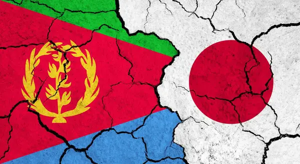 Flags of Eritrea and Japan on cracked surface - politics, relationship concept