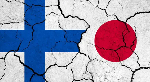 Flags of Finland and Japan on cracked surface - politics, relationship concept