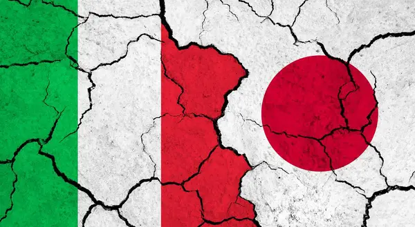 Flags of Italy and Japan on cracked surface - politics, relationship concept