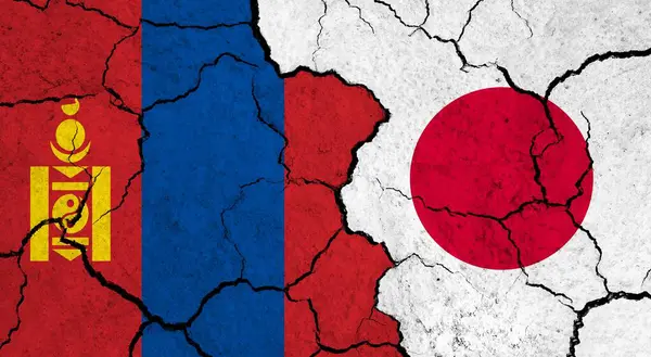Flags of Mongolia and Japan on cracked surface - politics, relationship concept