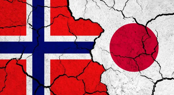 Flags of Norway and Japan on cracked surface - politics, relationship concept