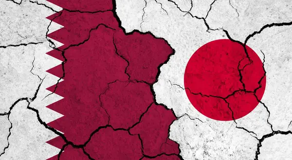 Flags of Qatar and Japan on cracked surface - politics, relationship concept