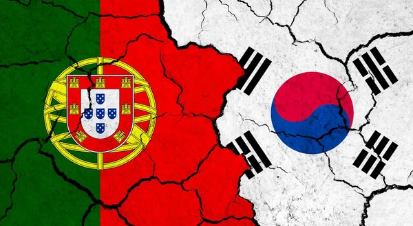 Flags of Portugal and South Korea on cracked surface - politics, relationship concept