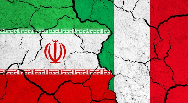 Flags of Iran and Italy on cracked surface - politics, relationship concept