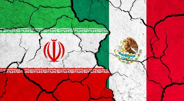 Flags of Iran and Mexico on cracked surface - politics, relationship concept