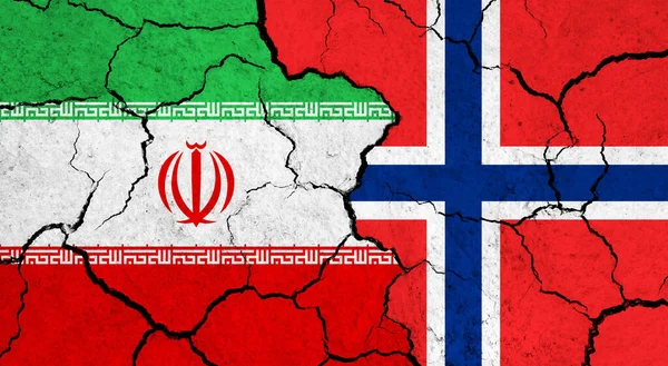 Flags of Iran and Norway on cracked surface - politics, relationship concept