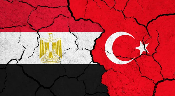 Flags of Egypt and Turkey on cracked surface - politics, relationship concept