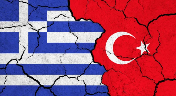 Flags of Greece and Turkey on cracked surface - politics, relationship concept