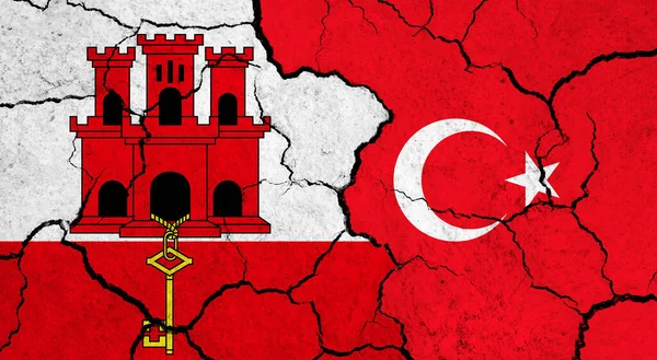 Flags of Gibraltar and Turkey on cracked surface - politics, relationship concept