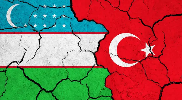 Uzbekistans Och Turkiets Flaggor Sprucken Yta Politik Relationskoncept — Stockfoto