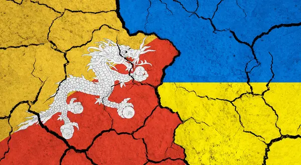 stock image Flags of Bhutan and Ukraine on cracked surface - politics, relationship concept