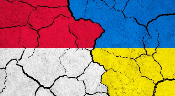 stock image Flags of Monaco and Ukraine on cracked surface - politics, relationship concept