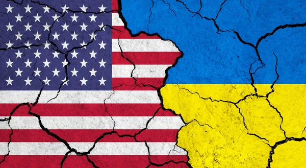 Flags of USA and Ukraine on cracked surface - politics, relationship concept