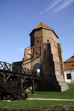 Liw, Poland - March 10th, 2024 - Gothic medieval castle and wooden footbridge clipart