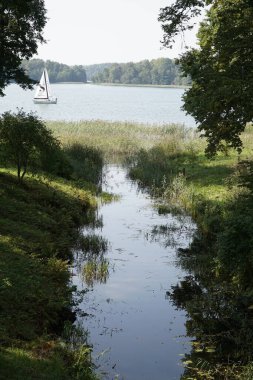Trakai, Lithuania - September 13th 2023 - Canal in park and Galve lake - Uzutrakis Manor, Tyszkiewicz family residence clipart