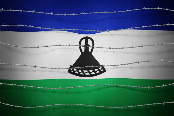 stock image Lesotho flag and barbed wire - 3d illustration