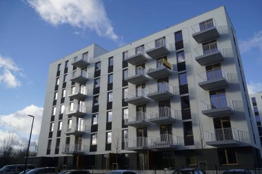 Warsaw, Poland, January 4th 2025 - Modern residential building with balconies. Real estate and housing issues concept. clipart